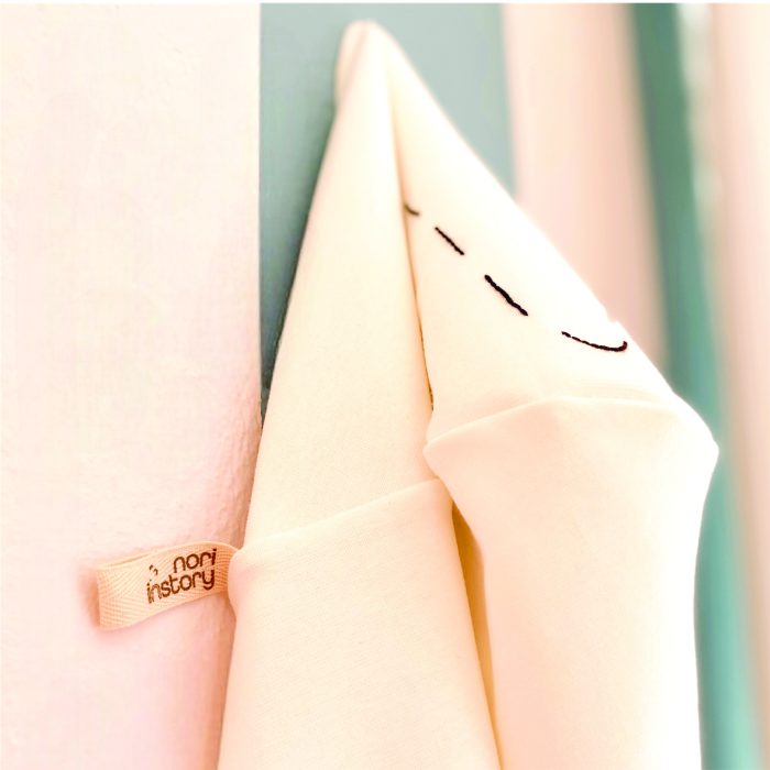 Hanging baby hooded towel with Nori in Story brand tag