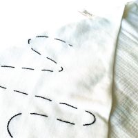 Close-up embroidery stitching on muslin baby hooded towel